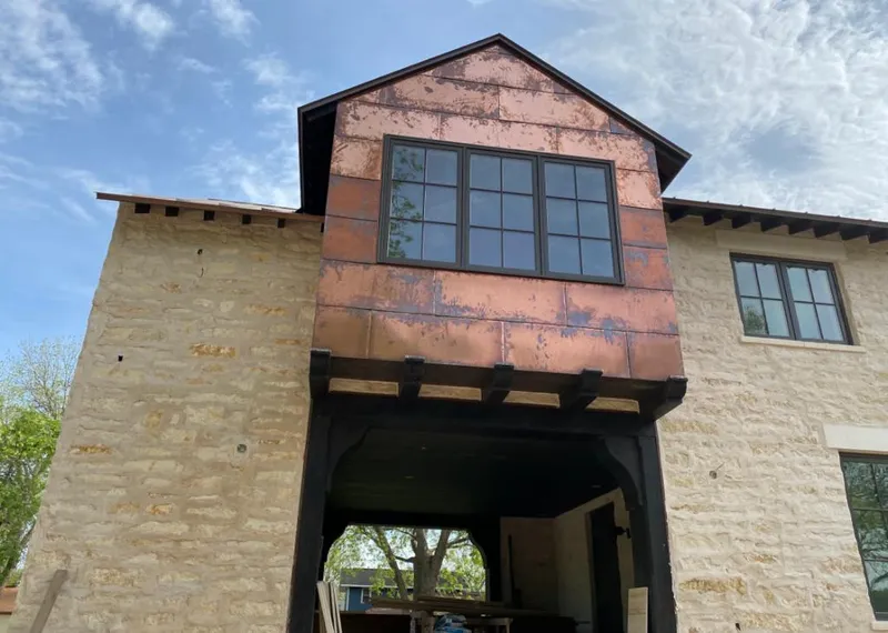 Copper metal panel facade on a stone building for Metal Roof Coating in Great Falls